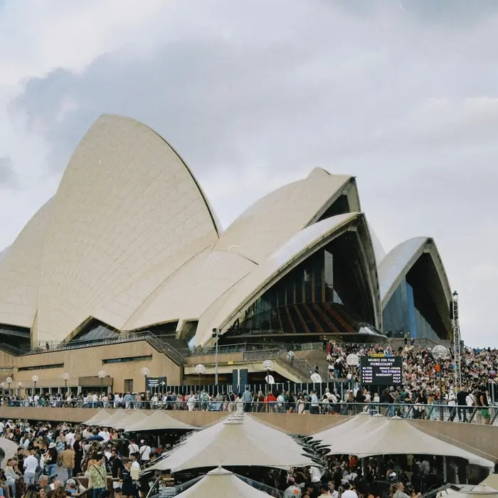A crowd gathering for an event outside the Sydney Opera House
