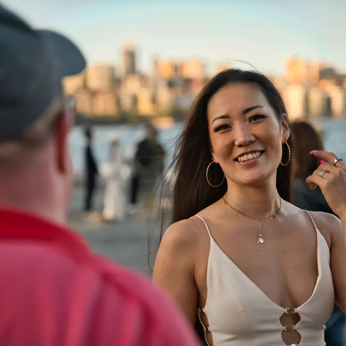 A smiling attendee at a photography meetup beside Sydney Harbour