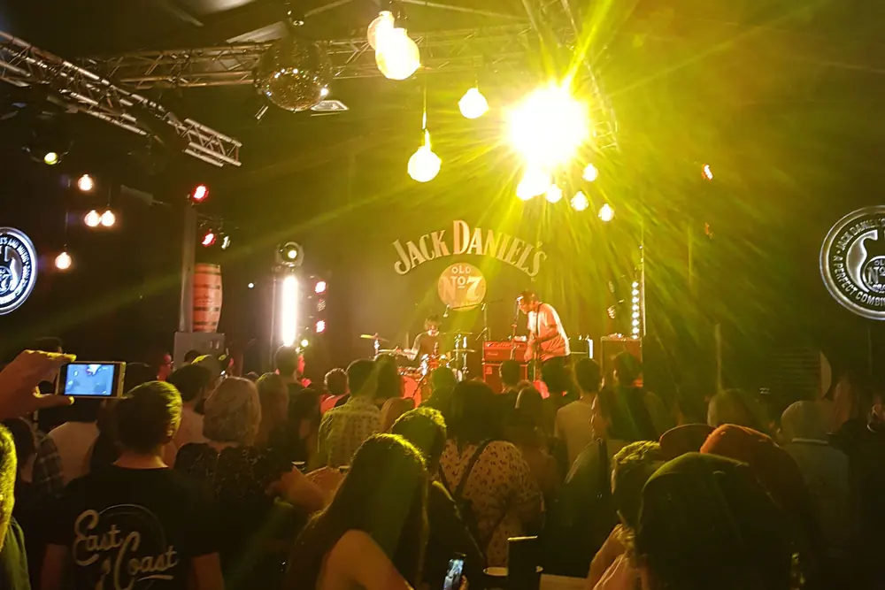 People enjoying a live indoor music performance in Australia